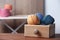 Colorful clews of threads in drawer on wooden table against blurred background