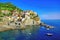 Colorful cliff side Cinque Terre village of Manarola, Italy along the sea