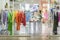 Colorful clothes on hangers, assortment in light clothing store, season shopping.