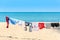 Colorful clothes hanging to dry on a laundry line and sun shining on the beach