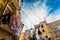 Colorful clothes tended to dry on the balconies of the old houses of an Italian city in the Mediterranean