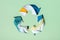 Colorful clothes under paper cut recycling symbol. Second hand, clothing donation and recycling reuse concept