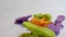 Colorful clothespin isolated on a white background. Clothespins are orange, green and purple. Close-up photo.