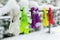 Colorful clothespins on clothesline covered with snow