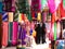 Colorful clothing for sale in India, with black-clad Muslim women
