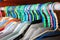 Colorful cloths hangers with office suit in closet orderly