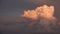 A colorful cloud cluster and a gray sunset in the sky