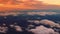 Colorful cloud in sky at sunrise viewed from airplane