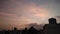 Colorful clouds during dusk and building silhouettes