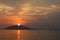 Colorful clouds  sunset  sea and island silhouettes and sea sparkle.