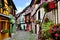 Colorful cobblestone lane in an Alsatian town, France