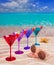 Colorful cocktail in a row with cherry on tropical sand beach