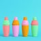 Colorful cocktail shakers on bright blue background in pastel colors. Minimalism concept