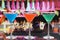 Colorful cocktails in Martini glasses in a bar