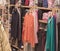 A colorful collection of women`s autumn and winter clothing hangs on a hanger in the store