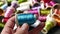 Colorful colored thread wound bobbins, spool of blue thread in a tailor\'s hand