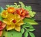 Colorful composition of handmade paper on a wood background. Papercraft flower.