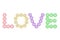 Colorful condoms arranged in LOVE text