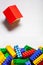 A colorful constructor set with the little house made from designer blocks close-up on the white background