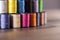 Colorful cotton reels stacked on a table