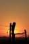 Colorful country Kansas Sunset with a fenceline silhouette out in the country.