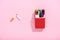 Colorful crayons in cigarette pack and broken tobacco cigarette on pink, smoking concept