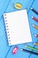 Colorful crayons, sharpener and notepad on blue boards, school accessories, copy space for text