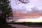 Colorful crimson summer sunset by the river