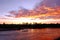 Colorful crimson summer sunset by the river