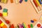 Colorful cubes, paints, pencils, blocks, modeling clay on orange background. Interesting math, games for preschool for kids.