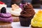 Colorful cupcakes with different Tastes. Small beautifull cakes on white table top. Close up