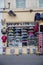 Colorful custom sneakers and sweatshirts displayed behind a store window