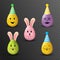 Colorful cute easter eggs with funny expression wearing party hats.