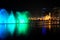 Colorful dancing fountain with mosque in the city at night with lively music