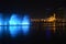 Colorful dancing fountain with mosque in the city at night with lively music