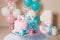 Colorful decoration of a first year birthday cake for twins. Happy birthday. White, pink, blue colors