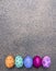 Colorful decorative painted eggs for Easter granite background top view close up