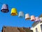 Colorful decorative retro style lampions or lamp hoods suspended on electrical wire overhead