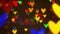Colorful defocused blinking heart bokeh festive lights as abstract background