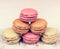 Colorful delicious macaroons on vintage wooden background