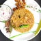 Colorful Delicious yummy prawn briyani with prawn fry in center with prawn fry and raita plated beautifully in white plate with