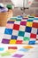 Colorful detail of quilt sewn from square pieces on sewing machine, traditional patchwork