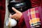 Colorful details of buddhist monk hands holding a bowl and cup