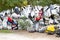 Colorful display of scrapped plastic fenders at automobile scrapyard