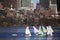 Colorful docked sailboats and Boston Skyline in winter on half frozen Charles River, Massachusetts, USA