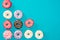Colorful donuts on blue. Appetizing background of donuts in minimalist style