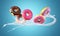 Colorful donuts flying with milk splash on blue background
