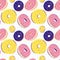 Colorful donuts. Seamless vector pattern on a white background. Delicious food dessert. Yellow, pink, blue colors