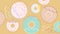 Colorful donuts set with sugar strands on beige background. Big and small size
