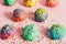 Colorful donuts with sugar strands on a messy background